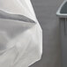A close up of a Lavex trash bag on a white object.