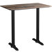 A Lancaster Table & Seating rectangular bar height table with a textured mixed plank finish and black legs.