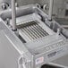 A Nemco 3/16" blade assembly set on a machine cutting a piece of food.