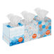 A group of Kleenex tissue boxes with blue and orange designs.
