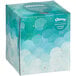 A Kleenex tissue box with blue and white clouds on the packaging.