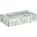 A white Kleenex box of tissues with gold triangles.