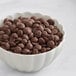 A bowl of Callebaut Recipe 811 dark chocolate callets.