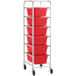 A metal Regency lug rack with red plastic tote boxes on it.