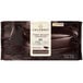 A white and brown package of Callebaut Recipe 811 Dark Chocolate Block with a bar of dark chocolate inside.