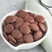 A bowl of Cacao Barry 70% Dark Chocolate pistoles.