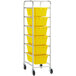 A Regency mobile aluminum lug rack with yellow plastic tote boxes on it.