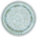 A close-up of a small melamine plate with a sea moss speckled design and a raised rim.