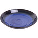 A blue bowl with a black rim and a swirl design on a table.