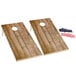 A Backyard Pro wooden cornhole game set with rustic dark wood boards with red, white, and blue stripes and holes.