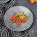 A Denali melamine plate with chili peppers on it.