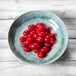 A Sea Moss melamine bowl filled with cherry tomatoes on a white table.