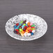 An Elite Global Solutions black marble embossed melamine plate with colorful jelly beans on it.
