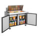 A Turbo Air 2 door refrigerated sandwich prep table with food inside.