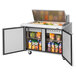 A Turbo Air 2 door mega top refrigerated sandwich prep table with food inside.