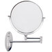A Conair wall-mounted mirror with a metal arm and frame on a wall.