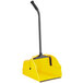 A Quickie yellow dustpan with a long black handle.