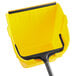 A yellow dustpan with a black handle.