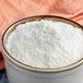 A white bowl of White Lily Self-Rising Cornmeal Mix.