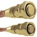 A close-up of two brass threaded connectors with gold and copper metal finishes.