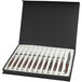 A set of Bon Chef Laguiole steak knives with red wood handles in a black box.