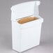 A white Rubbermaid sanitary napkin receptacle with a brown paper bag inside.