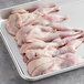 A white tray of raw Manchester Farms semi boneless quail.