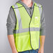 A man wearing a lime Ergodyne GloWear safety vest.