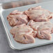 Manchester Farms raw quail breasts with wings on a tray.