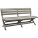 A grey Grosfillex faux wood bench with a back rest and two seats.