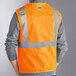 An Ergodyne orange mesh safety vest with reflective stripes.
