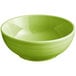 A green Acopa Capri stoneware bowl with a white rim on a white background.