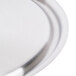 A close-up of a silver stainless steel plate with a loop handle.