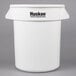 A white Continental Huskee 20 gallon round trash can with black text.