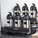A Bunn two tier universal airpot rack holding six coffee containers.