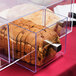 A loaf of bread in a clear acrylic container.