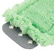 A close-up of a green fuzzy Unger SmartColor MicroMop pad.