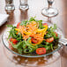 A salad with tomatoes, peppers, and cheese on an Anchor Hocking glass luncheon plate.