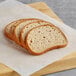 Slices of Schar Gluten-Free deli style sourdough bread on a cutting board.