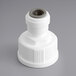 A white plastic pipe fitting with a grey cap.