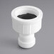 A white plastic pipe fitting with a black cap.