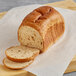 A loaf of Schar Gluten-Free Artisan Multigrain Bread on a cutting board.