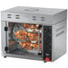A large Vollrath countertop rotisserie oven with chicken meat inside.