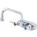 A T&S chrome wall mount faucet with two handles and a blue handle.