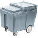 A grey plastic container with wheels.