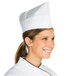 A woman wearing a Royal Paper white chef's hat.