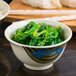 A close up of a Thunder Group round melamine rice bowl filled with rice.