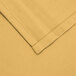 A yellow square cloth with a white hem.
