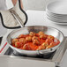 A Vigor stainless steel pan with meatballs in sauce.