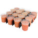 A Sterno School Nutrition Parfait Divider with plastic cups of fruit juice in it.